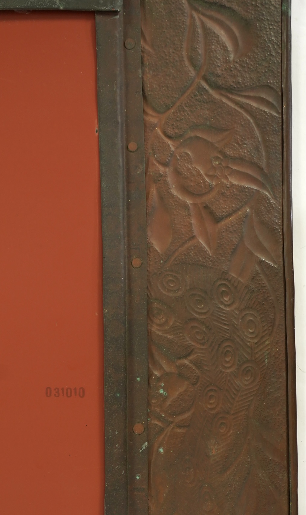 An Arts and Crafts embossed copper mirror, manner of Talwin Morris, Glasgow School